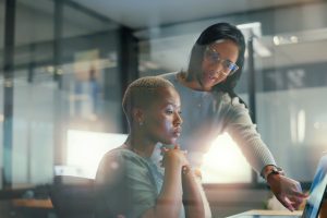 Teamwork, communication or business women on laptop in meeting for analytics, planning or project management. Research, SEO coaching or collaboration on tech for collaboration, strategy or review