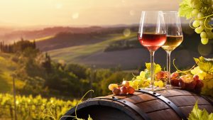 Glass,Of,Wine,With,Grapes,And,Barrel,On,A,Sunny
